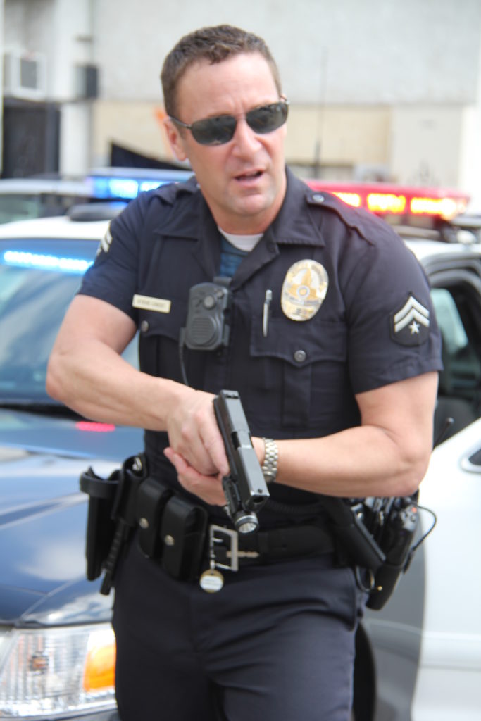 Cop with gun drawn.