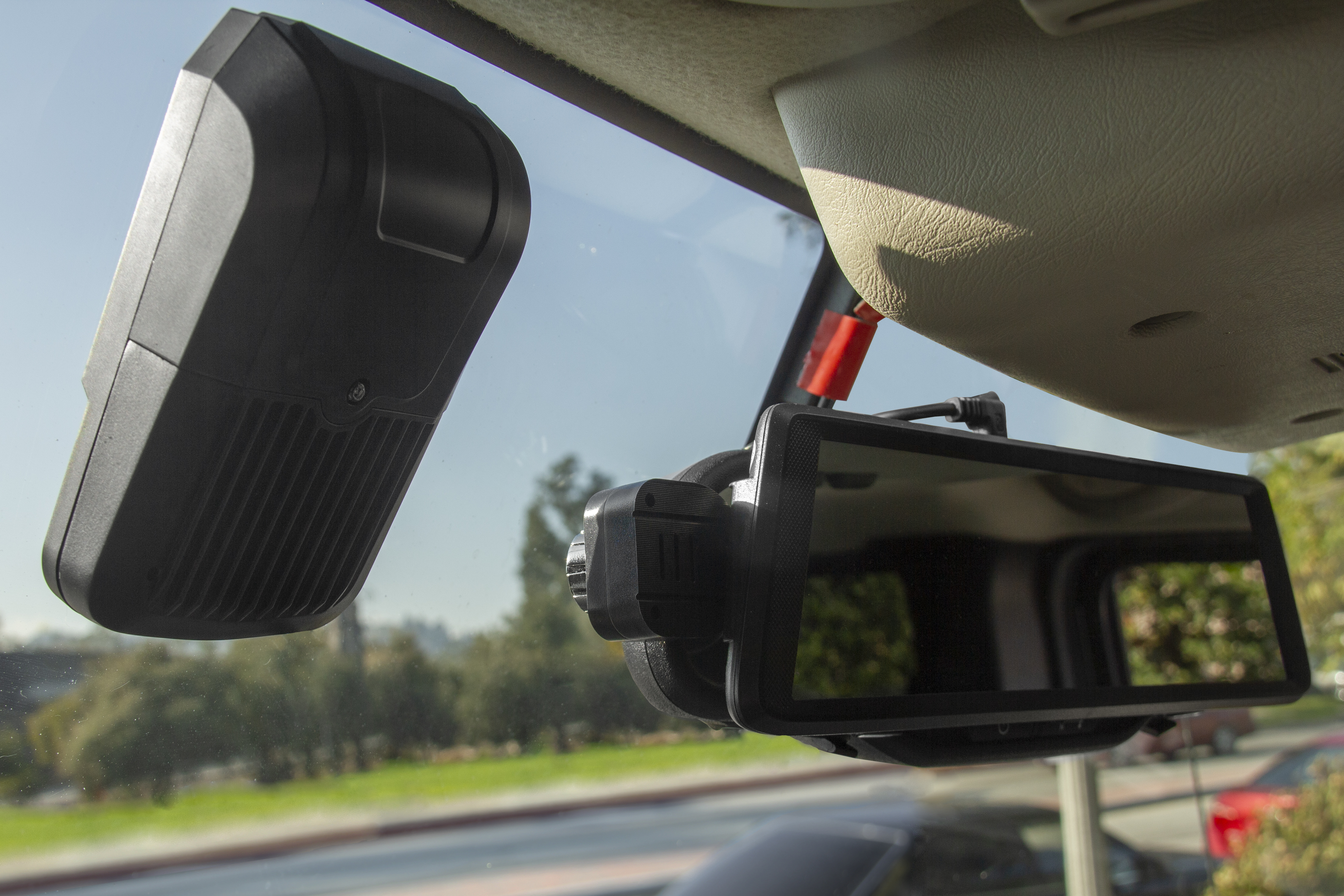 WOLFCOM front-facing in-car camera mounted on a windshield
